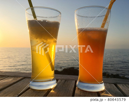Frozen cocktail glasses over sunset Frozen cocktail glasses over sunset 80643579