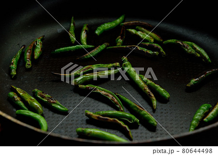 Grilled green chili pepper on pan 80644498