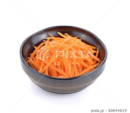 fresh shredded carrots in bowl on white background 80644819