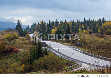 Hazy and overcast Carpathian Mountains and highway on mountain pass, Ukraine. Hazy and overcast Carpathian Mountains and highway on mountain pass, Ukraine. 80644989