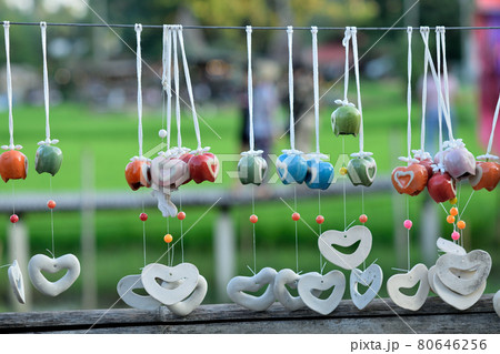 Colorful  hanging mobile  aganist blurred nature background 80646256