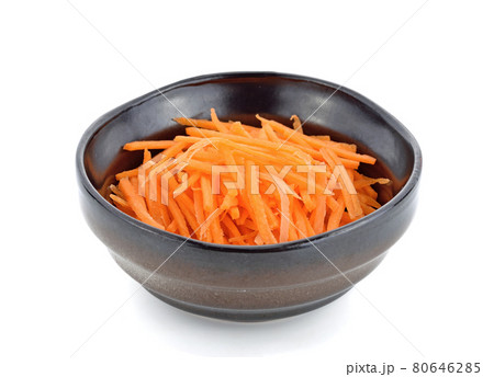 Fresh shredded carrots in bowl on white background Fresh shredded carrots in bowl on white background 80646285