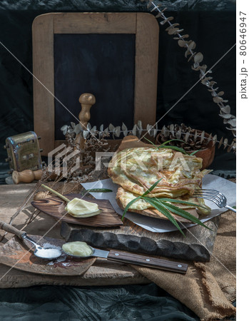 Homemade sweet frying roti (Cannabis Pancake) with cannabis and marijuana leaf on old wooden table. Homemade sweet frying roti (Cannabis Pancake) with cannabis and marijuana leaf on old wooden table. 80646947