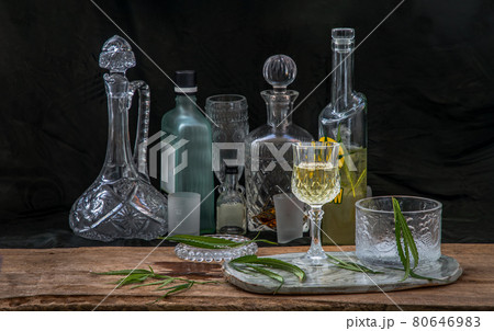 Ice cold Marijuana cannabis CBD infused drink in a crystal clear glass with green marijuana leaf on wooden background. 80646983
