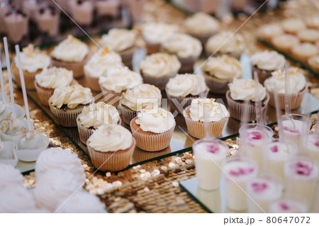 Cake bar on wedding. Differnt type of sweeties on the table. Eclair, cake pops, muffins and mamy others desserts Cake bar on wedding. Differnt type of sweeties on the table. Eclair, cake pops, muffins and mamy others desserts 80647072