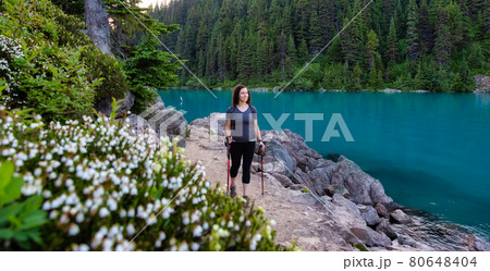 Adventurous White Caucasin Adult Woman Hiking on a trail in Canadian Nature Adventurous White Caucasin Adult Woman Hiking on a trail in Canadian Nature 80648404