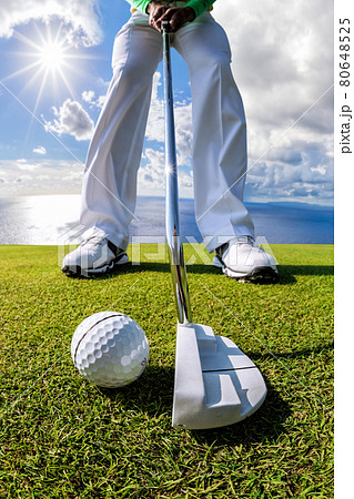 Man playing golf against azure sea in a coastal golf club Man playing golf against azure sea in a coastal golf club 80648525