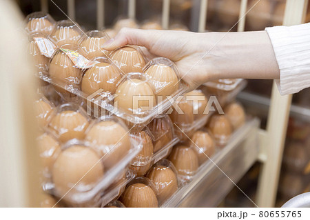 スーパーで卵パックを手に取る若い女性手元 スーパーで卵パックを手に取る若い女性手元 80655765