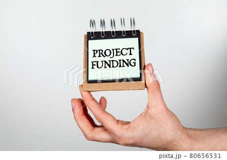 Project Funding. Notebook in woman's hands on a white background 80656531