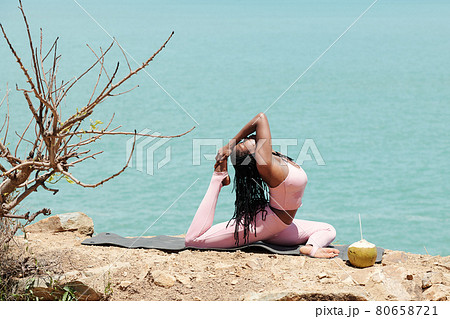Sportswoman Doing King Pigeon Pose Sportswoman Doing King Pigeon Pose 80658721