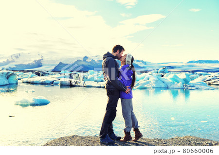 Kissing romantic couple in love on Iceland. by Jokulsarlon glacial lagoon, Iceland. 80660006