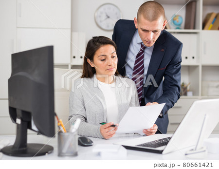 Businessman and business woman working together at office 80661421