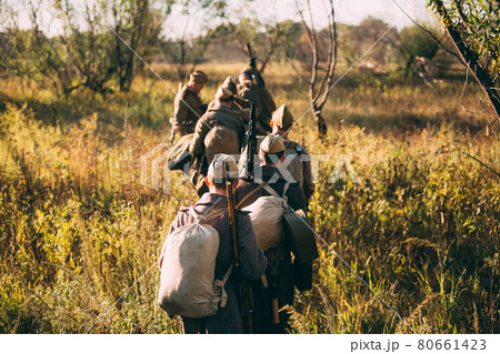 Group of unidentified re-enactors dressed as russian soldiers goes along meadow Group of unidentified re-enactors dressed as russian soldiers goes along meadow 80661423
