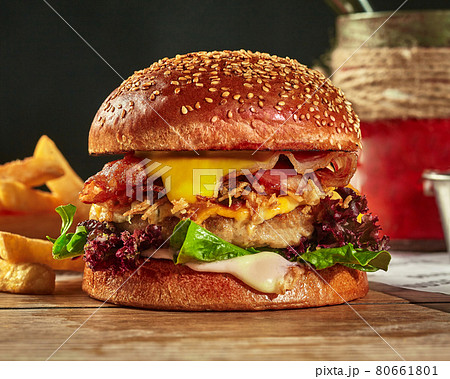 Cheeseburger with chicken patty, fried onion and bacon in sesame bun 80661801