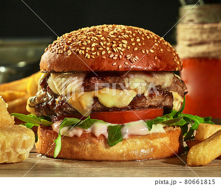 Burger with two patties, cheese, tomatoes and greens in sesame bun Burger with two patties, cheese, tomatoes and greens in sesame bun 80661815