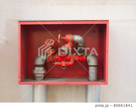 building's fire hose connections with red handles in a red box building's fire hose connections with red handles in a red box 80661841