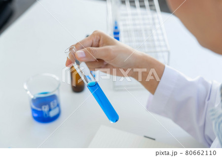 Scientist wear lab coat and protective wear are working with research or doing investigations with test tubes in experiment, Laboratory and development concept 80662110