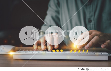 Hand using keyboard with Happy icon and Five stars for service rating feedback of experience customer survey. Business annual satisfaction  concept. Many sad or happily icons, excellent performance. 80663852