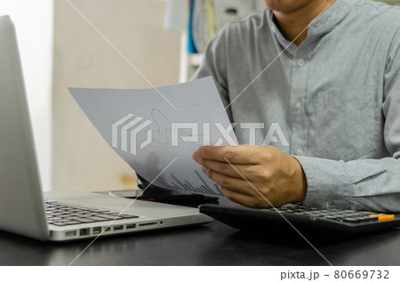 Business Man using calculator at a desk. Business finance, tax, and investment concepts. Business Man using calculator at a desk. Business finance, tax, and investment concepts. 80669732
