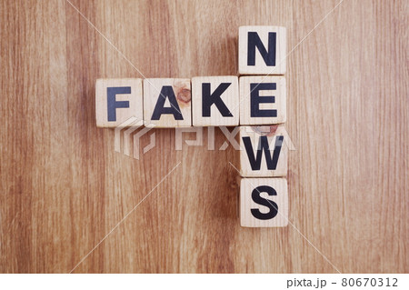 Fake News word alphabet letters on wooden background 80670312