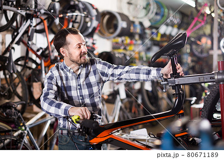 Male is fixing bicycle parts Male is fixing bicycle parts 80671189
