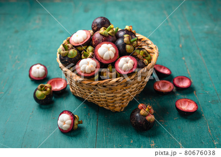 Mangosteen fruit on light blue wooden background Mangosteen fruit on light blue wooden background 80676038