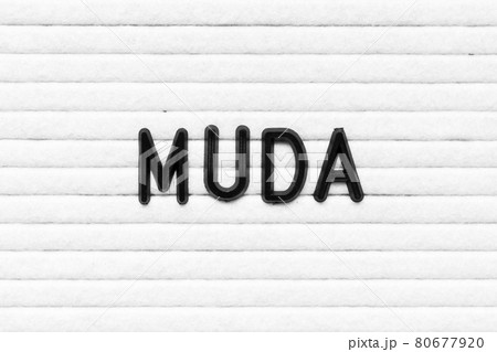 Black alphabet letter in word muda on white felt board background 80677920
