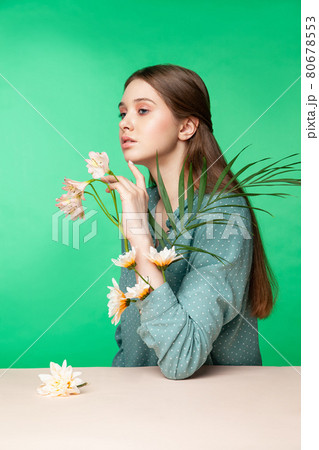 Young woman with flowers in blouse sleeves Young woman with flowers in blouse sleeves 80678553