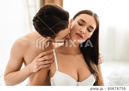 Husband Kissing Wifes Neck Making Love At Home - Stock Photo 80678756