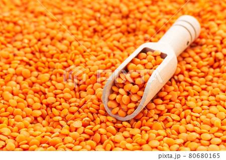 Wooden scoop with organic raw red lentils Wooden scoop with organic raw red lentils 80680165
