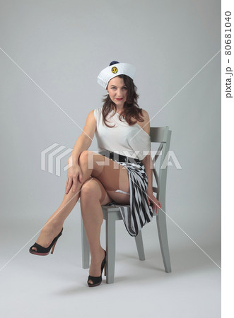 Beautiful woman with perfect hair and make-up in a sailor costume. 80681040
