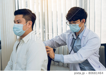 Asian doctor is using a stethoscope listen to the heartbeat of the patient. 80681464