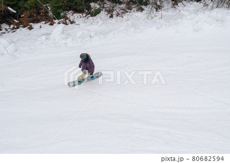 Snowboarder riding on White Snow Covered Slope top view Snowboarder riding on White Snow Covered Slope top view 80682594