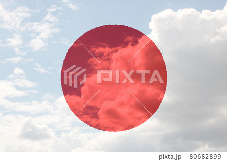 Japan flag in hand on blue sky with clouds Japan flag in hand on blue sky with clouds 80682899