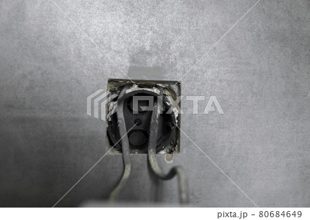 Repair or installation of a new light switch in the wall. Light switch connected via cables to a electricity in a home. 80684649