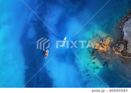 Aerial view of people on floating sup boards on blue sea 80684984
