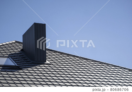 Brown corrugated metal profile roof installed on a modern house. The roof of corrugated sheet. Roofing of metal profile wavy shape. Modern roof made of metal. Metal roofing. Brown corrugated metal profile roof installed on a modern house. The roof of corrugated sheet. Roofing of metal profile wavy shape. Modern roof made of metal. Metal roofing. 80686706