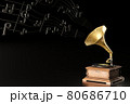 Old antique Gramophone or Phonograph and black music notes in dark black background. It's a popular mythical music player. It works by wind up. The concept of music and aesthetics. 80686710