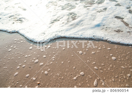 Close Up Wave Sand Beach Sea Foam. Closeup of sea wave with foam on beach sand. Vacation Summer background Close Up Wave Sand Beach Sea Foam. Closeup of sea wave with foam on beach sand. Vacation Summer background 80690054
