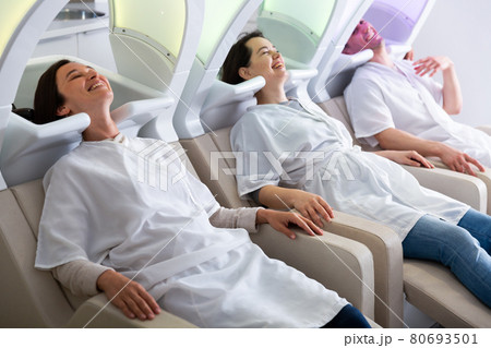 Portrait of clients resting in massage chairs for washing hair 80693501