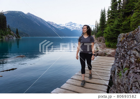 Adventurous White Caucasin Adult Woman Hiking on a trail in Canadian Nature Adventurous White Caucasin Adult Woman Hiking on a trail in Canadian Nature 80693582