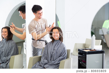 Woman client in during cuts hair at beauty salon Woman client in during cuts hair at beauty salon 80693809