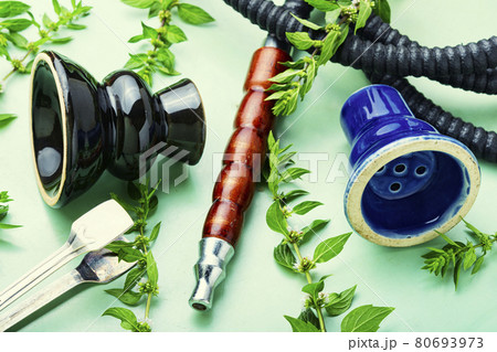 Smoking hookah with fresh mint 80693973