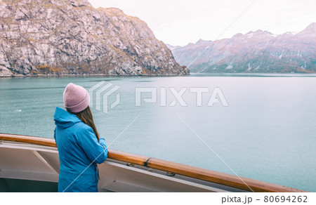 Alaska cruise Inside passage travel tourist woman looking at mountains landscape from balcony deck of ship. Glacier bay scenic vacation travel holiday 80694262