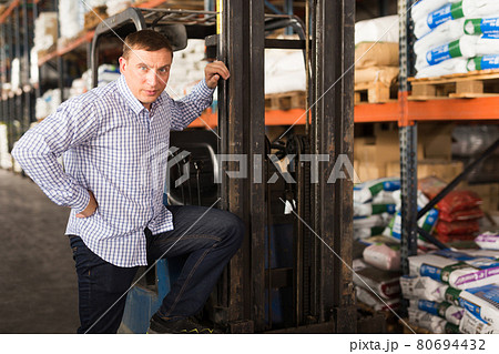 Man near forklift in hypermarket 80694432