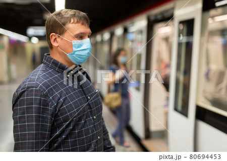 Male in disposable mask waiting for subway train 80694453