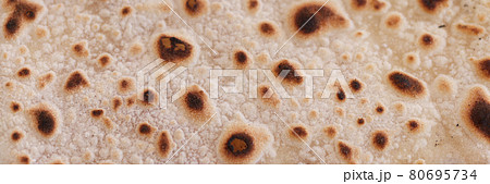 Toasted sweet flour pancake closeup. Fast cooking pancakes for breakfast Toasted sweet flour pancake closeup. Fast cooking pancakes for breakfast 80695734