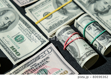 US dollars bundle close up isolated on dollar background. Paper denominations of dollars cash rolls with rubber bands. Business budget of wealth and prosperity finance. 80696362