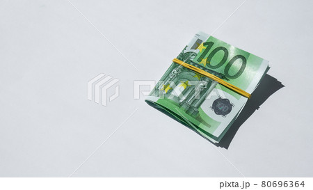 Close up of Euro money roll. Euro banknote set cash money - EU currency. Rolled with rubber euro notes. Banknotes stacked on each other in different positions Close up of Euro money roll. Euro banknote set cash money - EU currency. Rolled with rubber euro notes. Banknotes stacked on each other in different positions 80696364