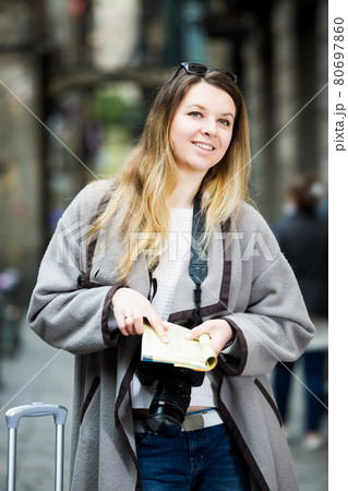 Woman having pamphlet and looking for her route 80697860